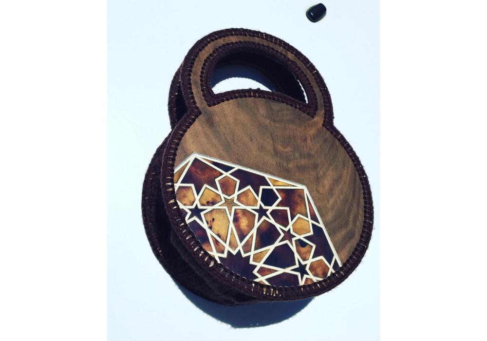 A bag made of olive wood decorated with camel bone and seashell